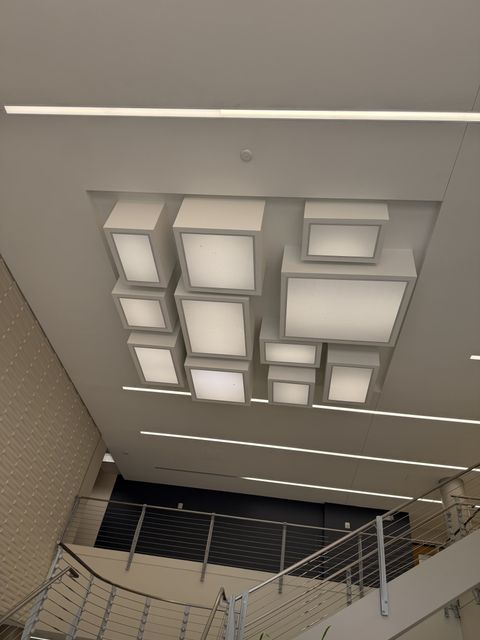 Sculptural light fixture above the lobby stair