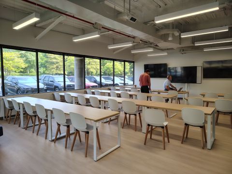 Classroom with full-height windows and pendant lighting